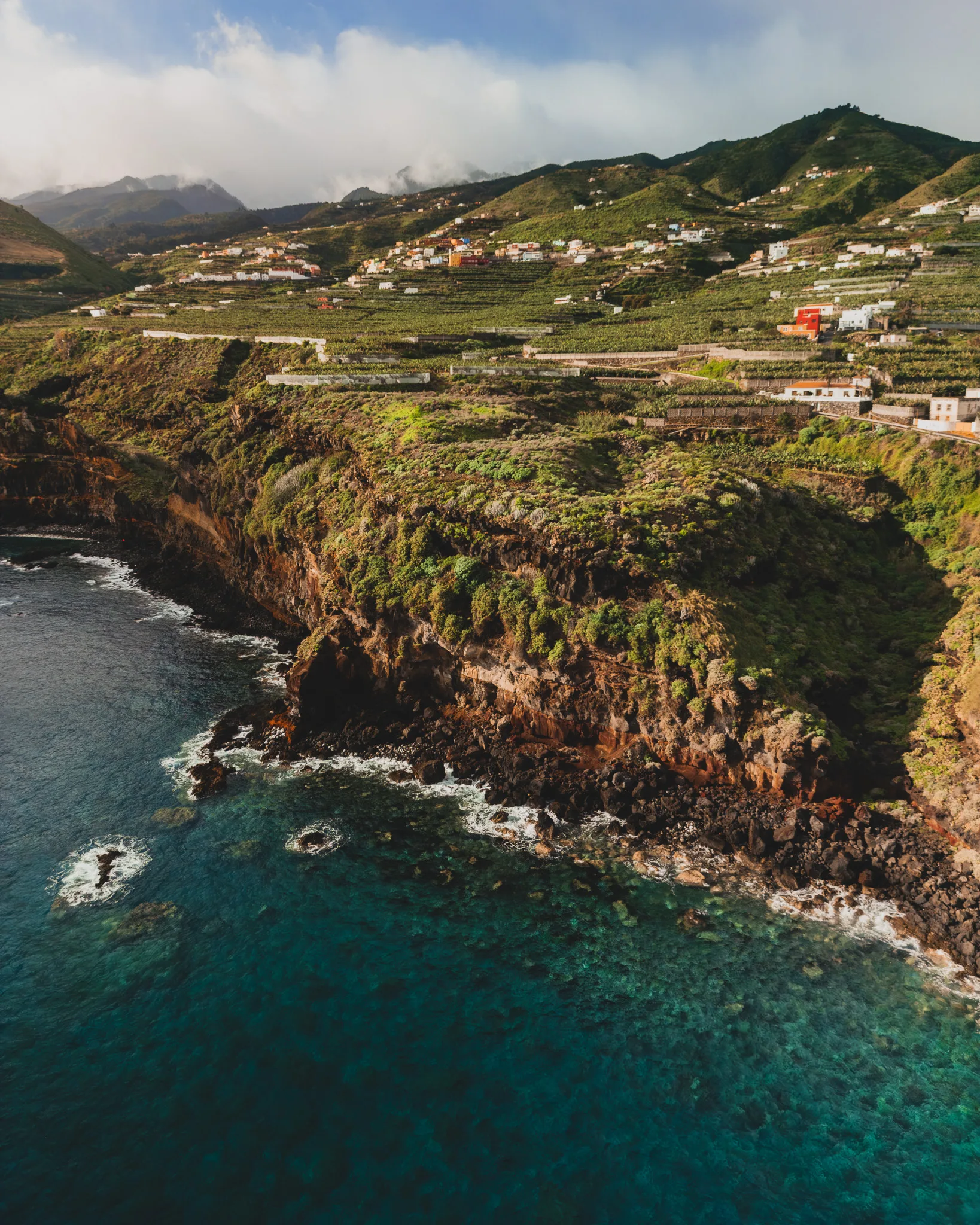 Klify nad turkusowym oceanem oraz zielone tarasy uprawne na zboczach wyspy, widok z lotu ptaka - Puerto de Talavera - La Palma